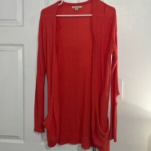 Sweater cardigan. Hole in left sleeve.